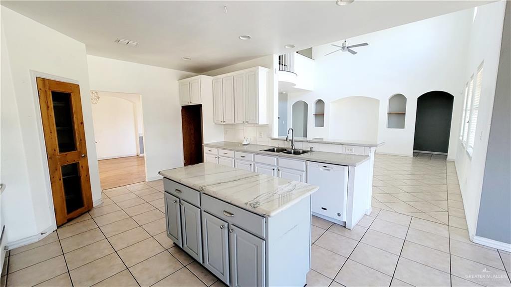 3003 El Jardin Street Mission, TX 78572 - Photo 9 of 25 a kitchen with stainless steel appliances granite countertop a sink and a stove