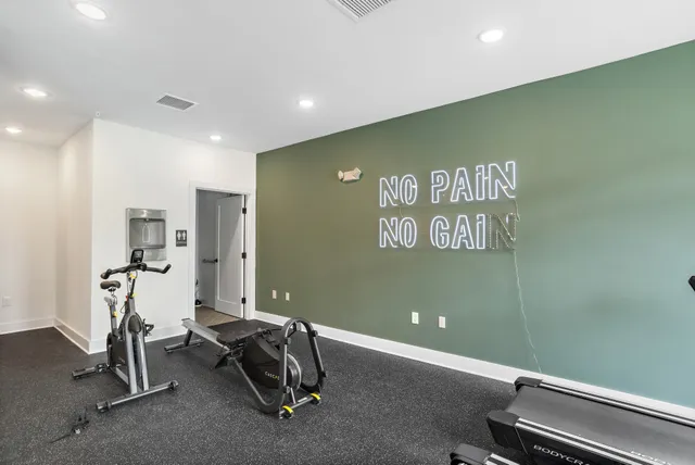 a kitchen with stainless steel appliances granite countertop a sink a stove a microwave a center island and a window