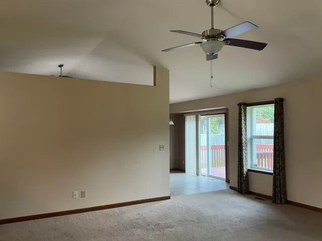 a view of a livingroom with a chandelier and dining table