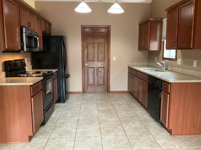a kitchen with a refrigerator stove and microwave