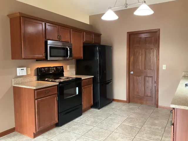 a kitchen with a stove a sink and a microwave