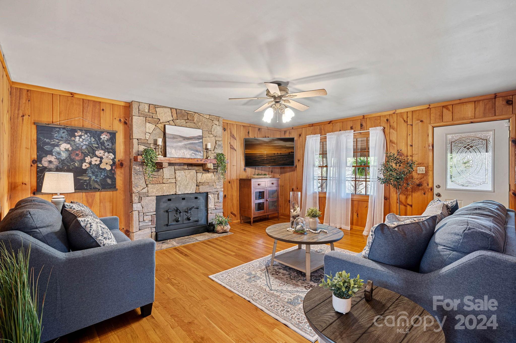 356 Eupeptic Springs Road Olin, NC 28660 - Photo 15 of 48 a living room with furniture fireplace and a large window