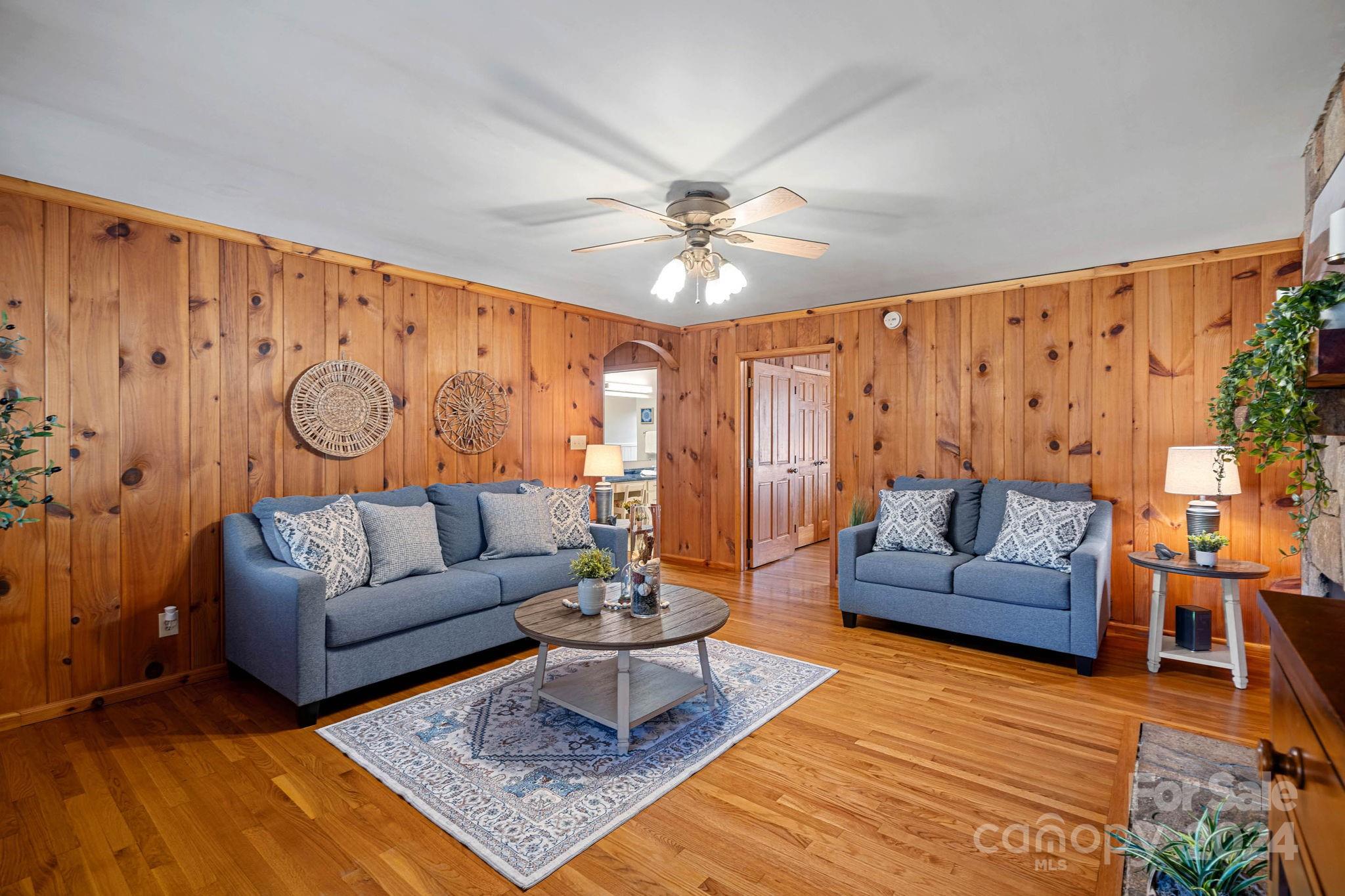 356 Eupeptic Springs Road Olin, NC 28660 - Photo 17 of 48 a living room with furniture a rug and a chandelier