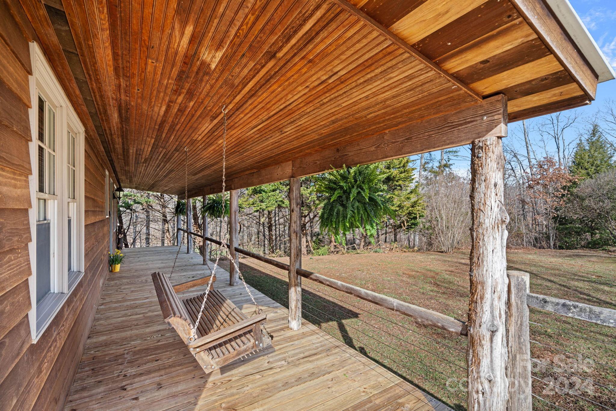 356 Eupeptic Springs Road Olin, NC 28660 - Photo 20 of 48 a view of a patio with table and chairs under an umbrella with a patio