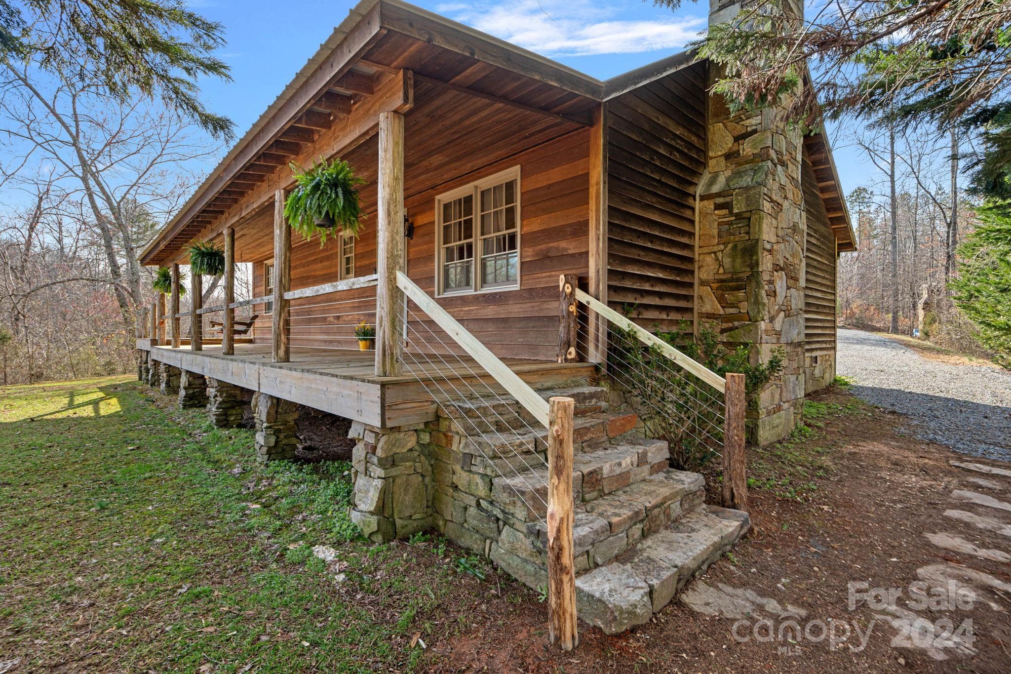 356 Eupeptic Springs Road Olin, NC 28660 - Photo 22 of 48 a view of wooden house with a yard