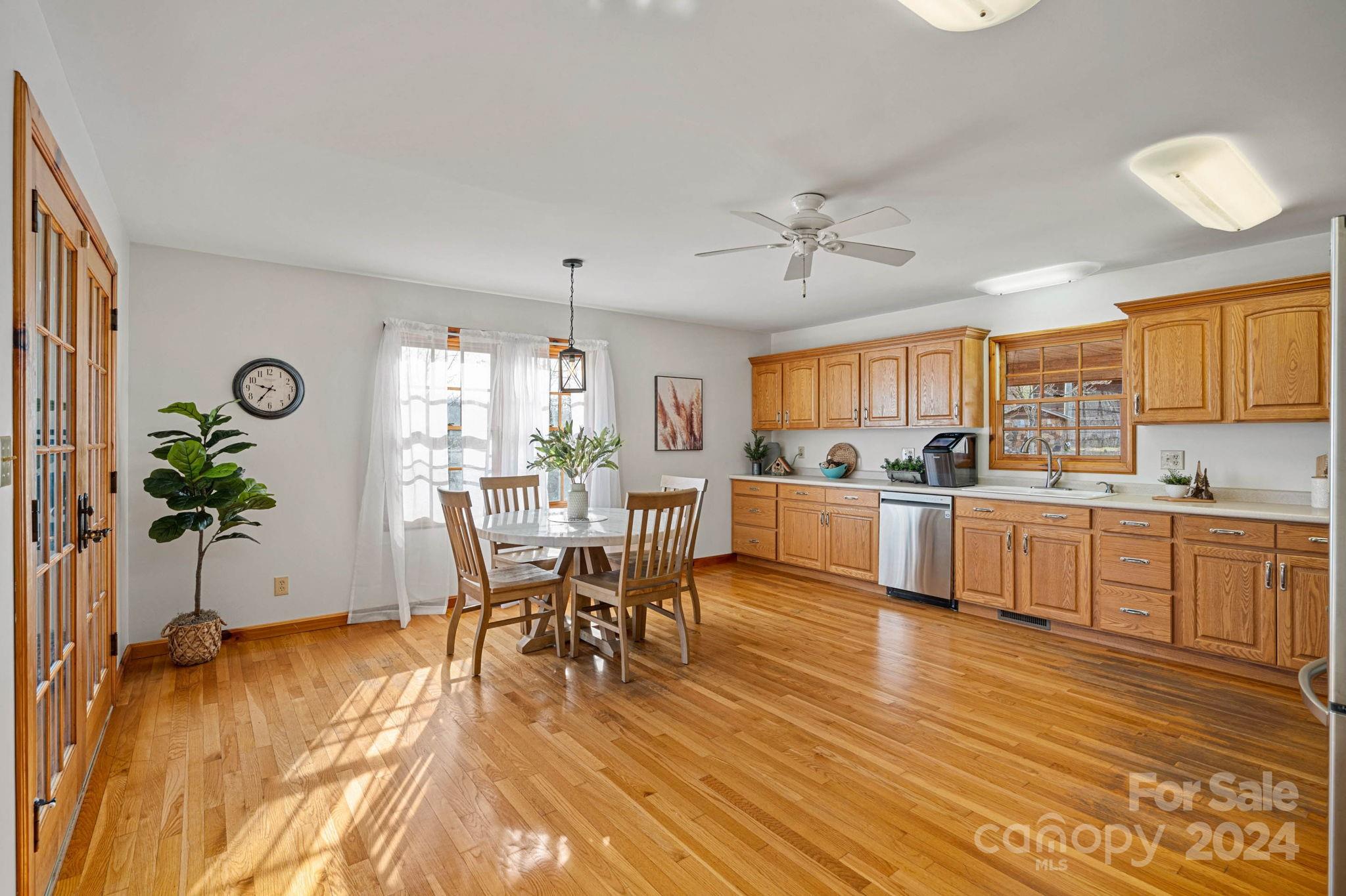 356 Eupeptic Springs Road Olin, NC 28660 - Photo 3 of 48 a kitchen with a table chairs refrigerator and cabinets