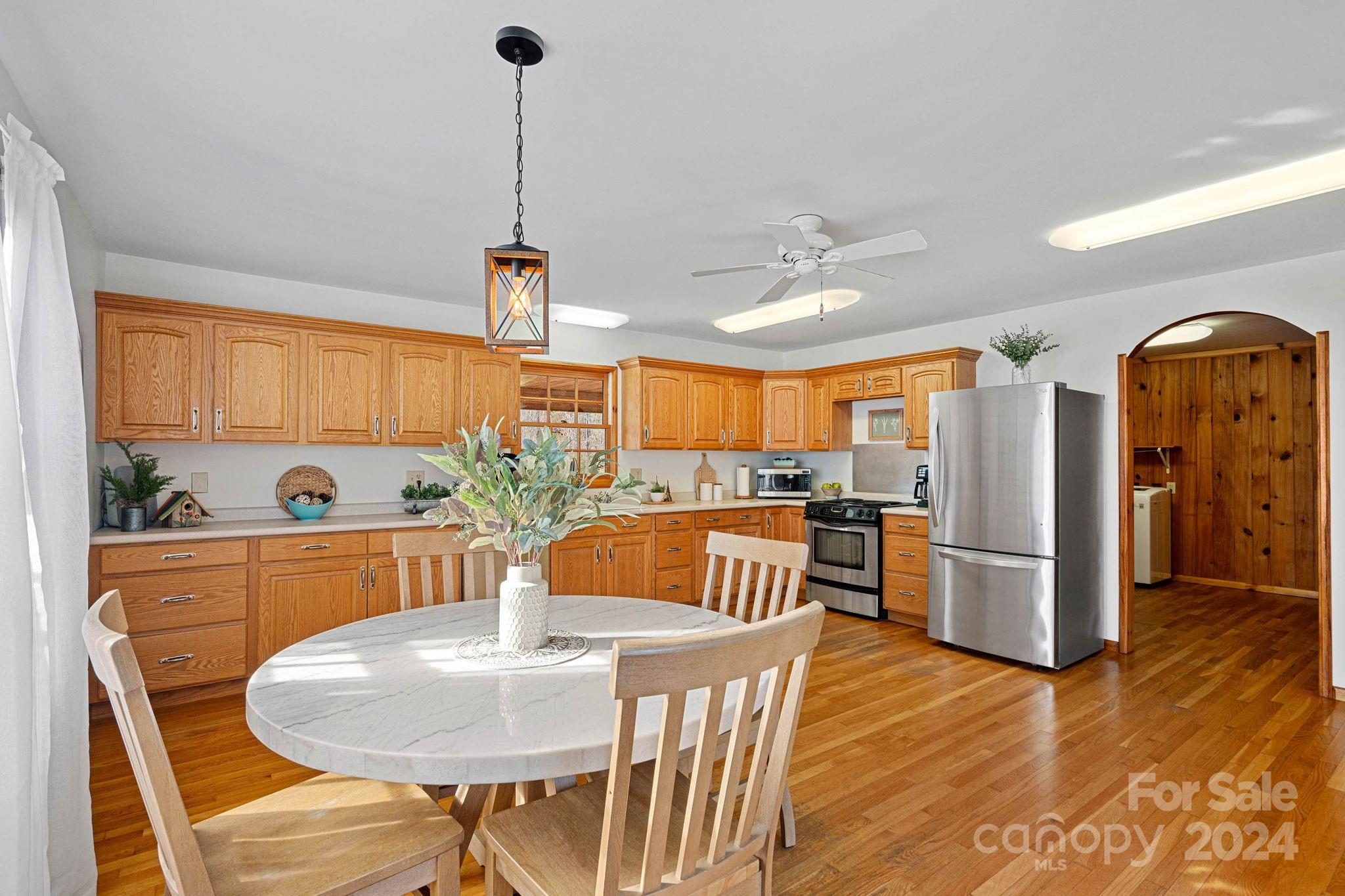 356 Eupeptic Springs Road Olin, NC 28660 - Photo 5 of 48 a view of a dining room with furniture window and wooden floor