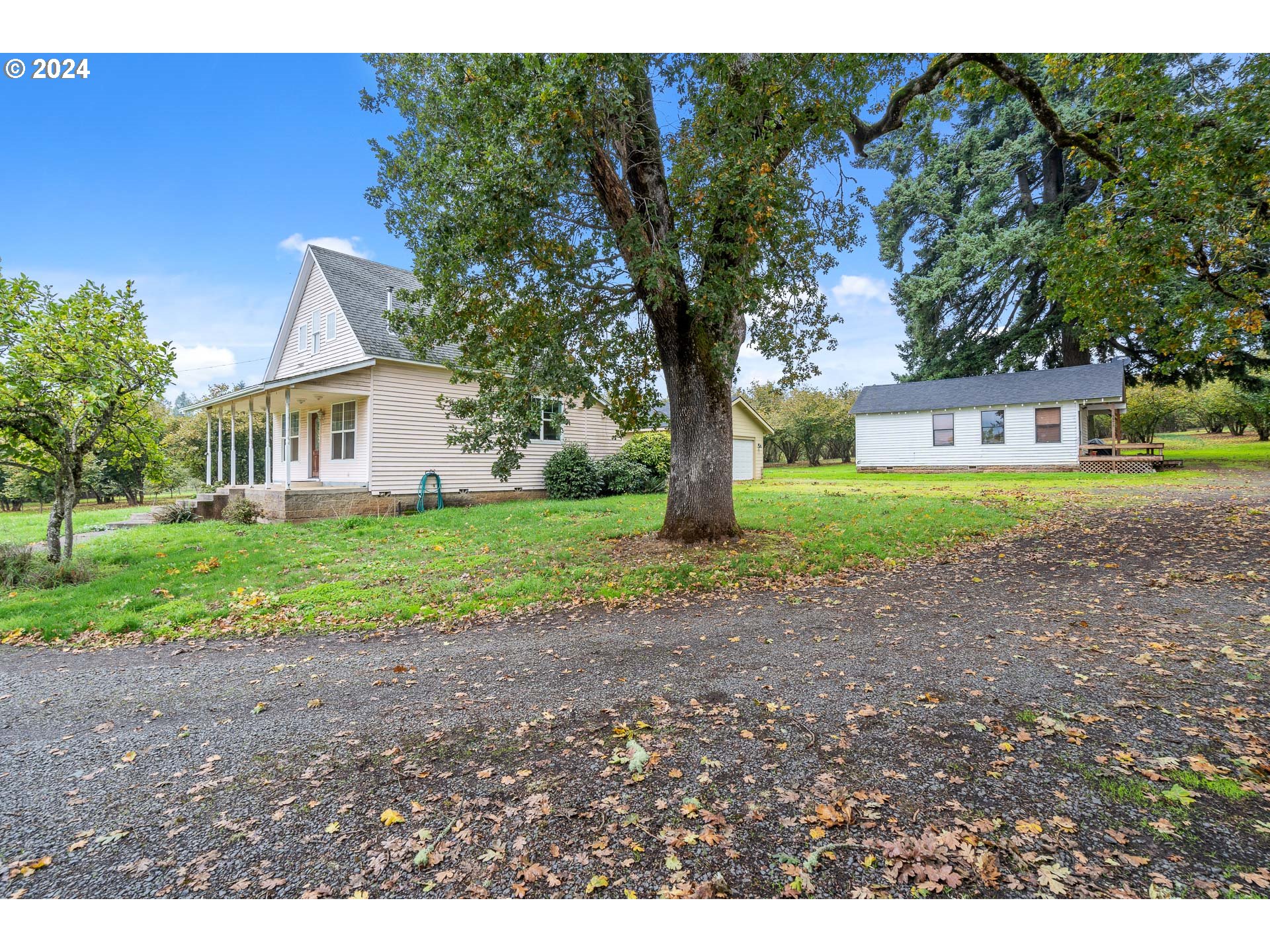 26413 Franklin Road Junction City, OR 97448 - Photo 12 of 44 a house with huge green field in front of it