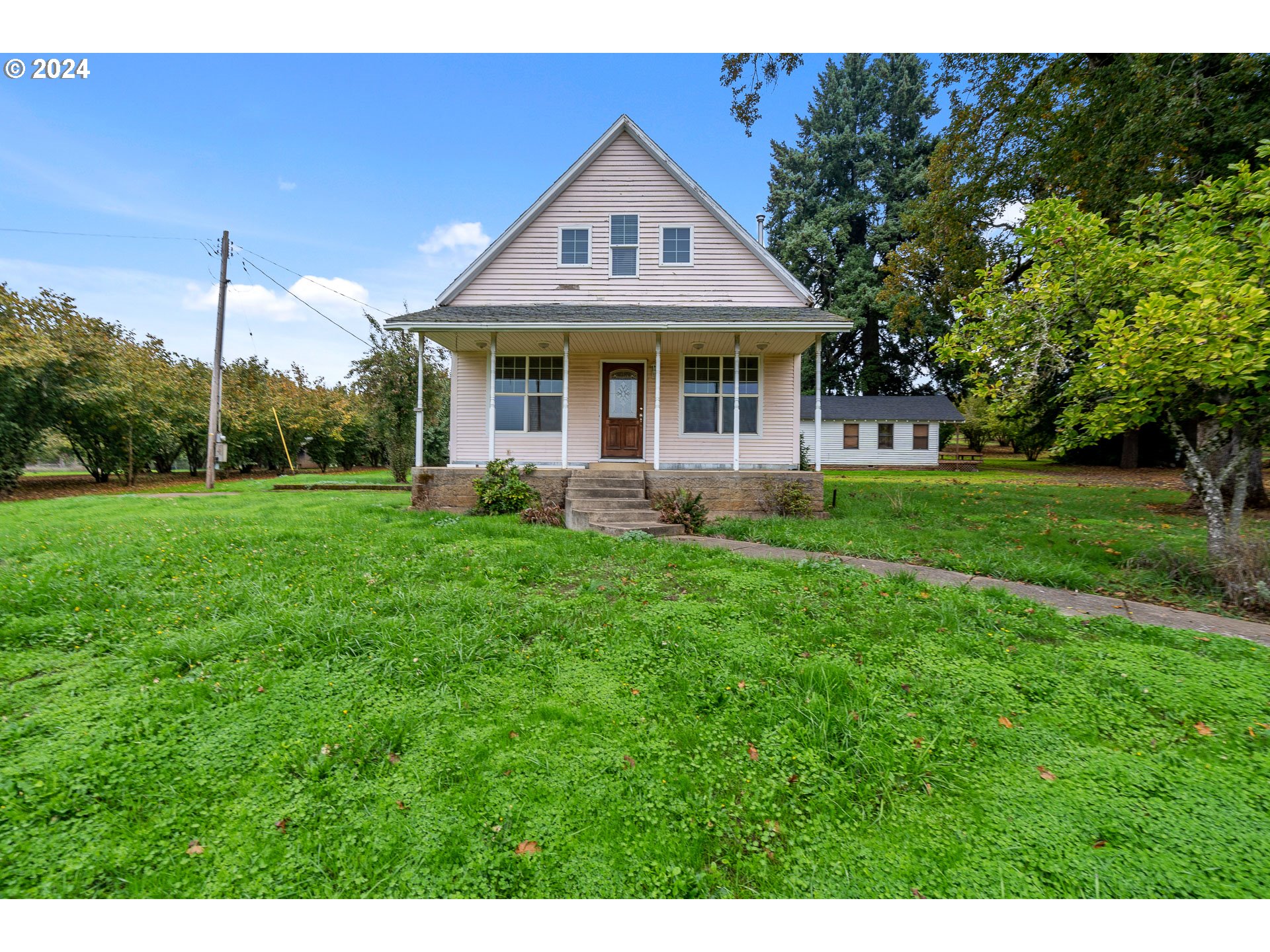26413 Franklin Road Junction City, OR 97448 - Photo 15 of 44 a front view of a house with a yard table and chairs