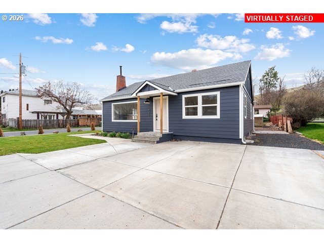a front view of a house with a garden