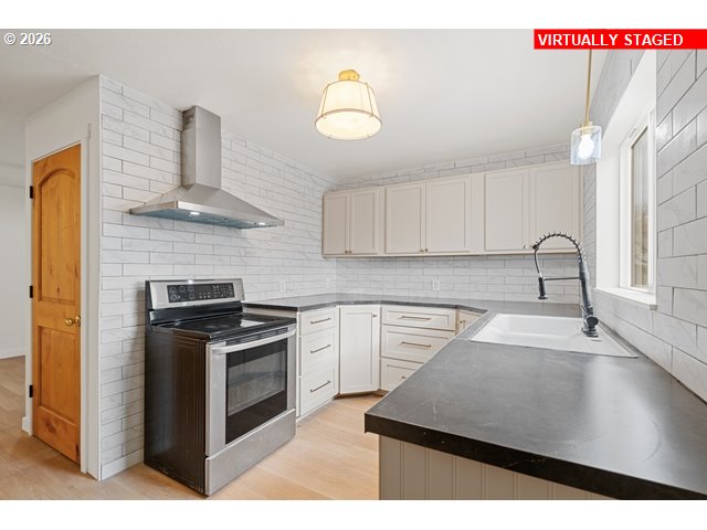 420 Water Street Heppner, OR 97836 - Photo 13 of 48 a kitchen with stainless steel appliances granite countertop a sink a stove and a microwave