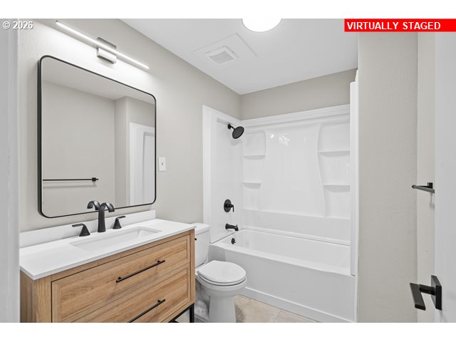 420 Water Street Heppner, OR 97836 - Photo 18 of 48 a bathroom with a double vanity sink toilet mirror and shower