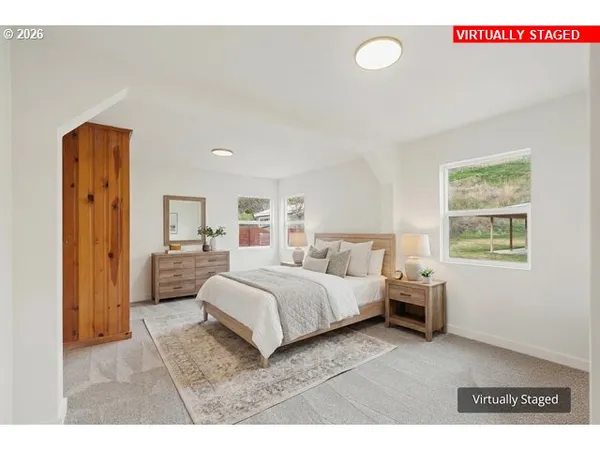 a living room with a bed furniture and a window