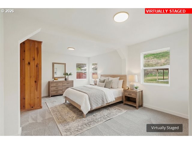 420 Water Street Heppner, OR 97836 - Photo 20 of 48 a living room with a bed furniture and a window