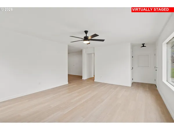 a view of an empty room with a ceiling fan