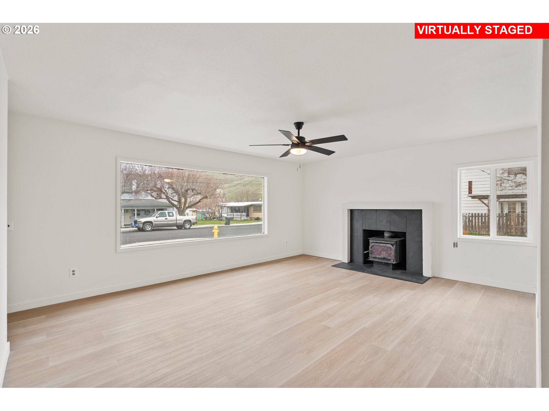 420 Water Street Heppner, OR 97836 - Photo 6 of 48 a view of an empty room with a window and fireplace