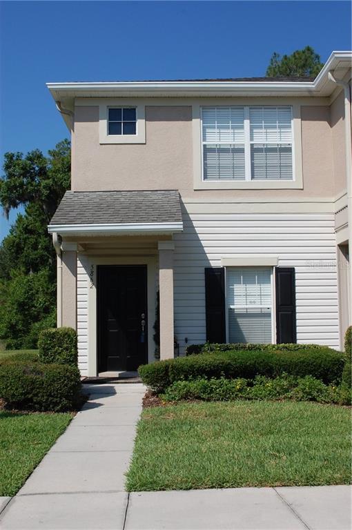 5862 Fishhawk Ridge Drive Lithia, FL 33547 - Photo 1 of 1 a view of a house with brick walls and a yard with plants