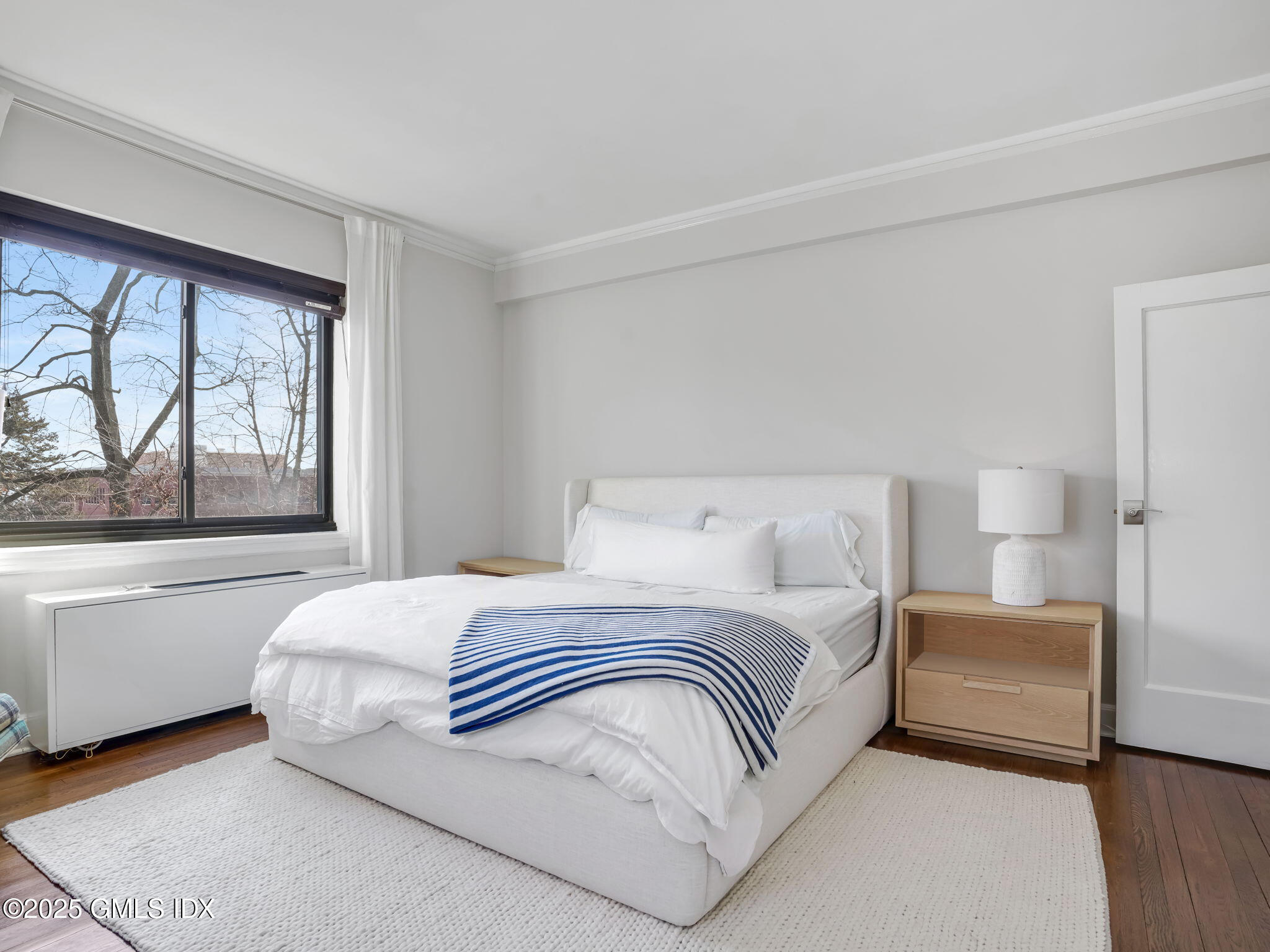47 Lafayette Place, Unit 3H Greenwich, CT 06830 - Photo 12 of 18 a bedroom with a large bed and a large window