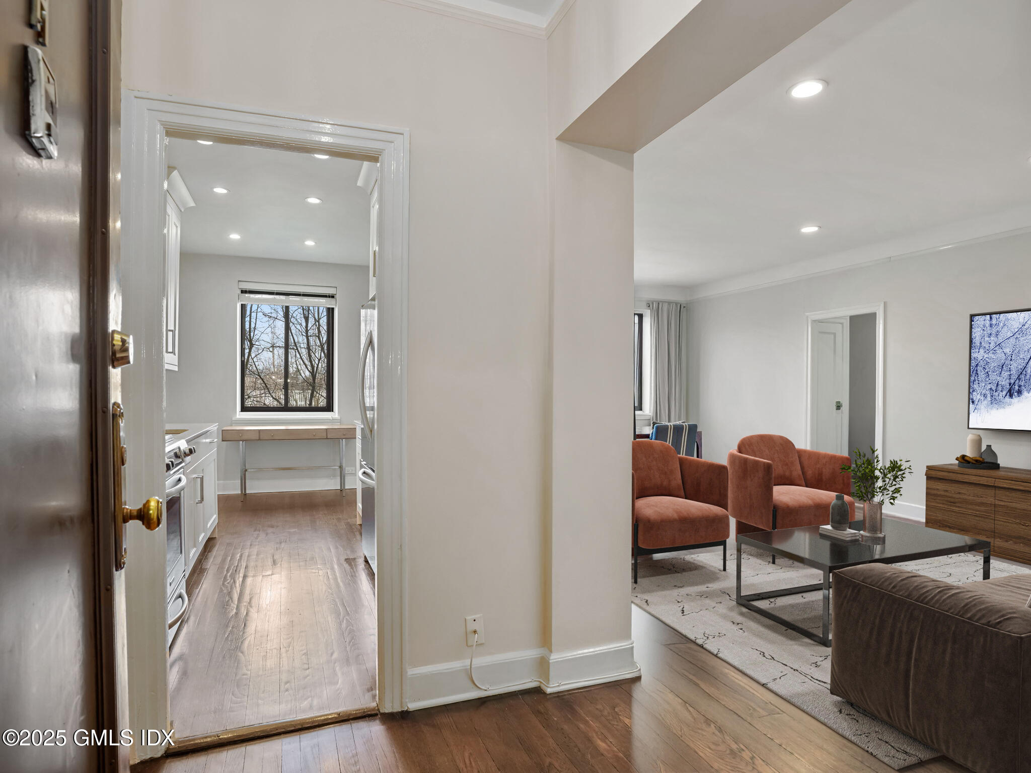 47 Lafayette Place, Unit 3H Greenwich, CT 06830 - Photo 2 of 18 a living room with furniture and a wooden floor