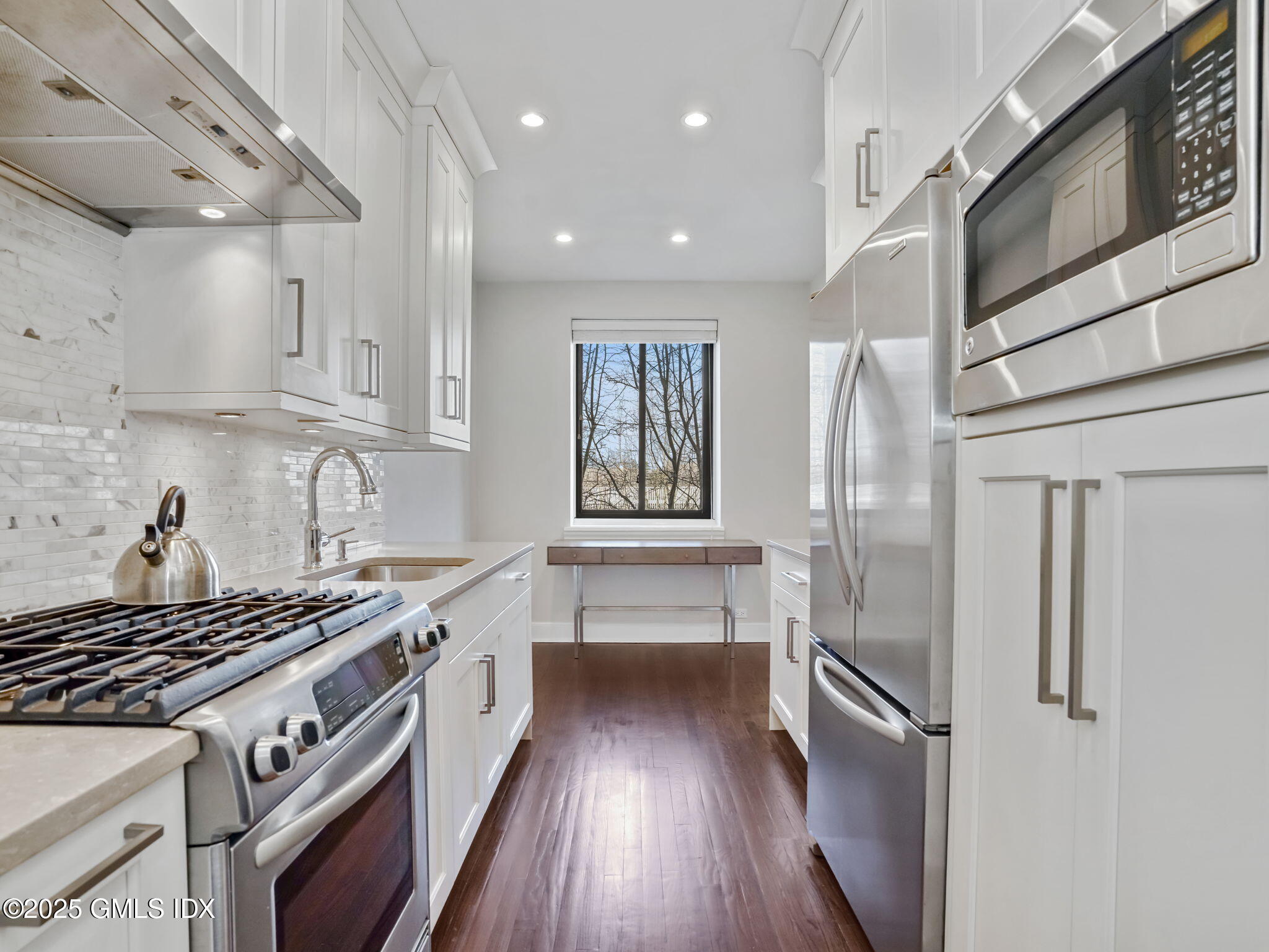 47 Lafayette Place, Unit 3H Greenwich, CT 06830 - Photo 4 of 18 a kitchen with stainless steel appliances granite countertop a stove a refrigerator and a stove