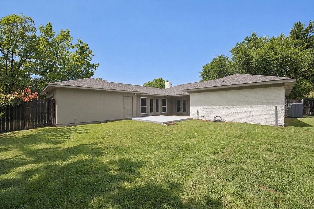 1904 Apollo Road Richardson, TX 75081 - Photo 35 of 40 Expansive backyard with a manicured lawn, a concrete patio, and a privacy fence