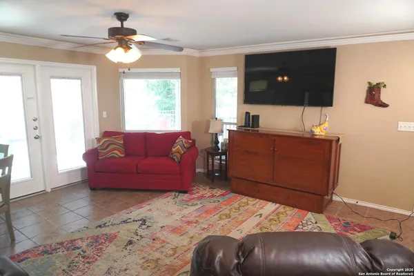 a kitchen with stainless steel appliances granite countertop a refrigerator a stove a sink dishwasher and white cabinets with wooden floor
