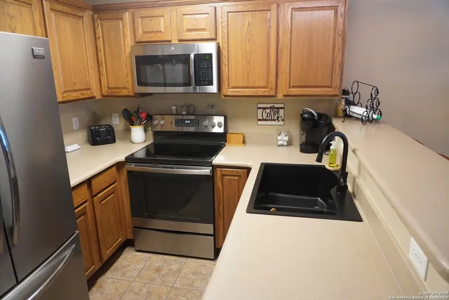 a kitchen with a sink a stove and cabinets