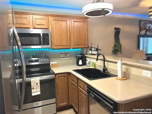 a kitchen with stainless steel appliances a refrigerator sink and microwave