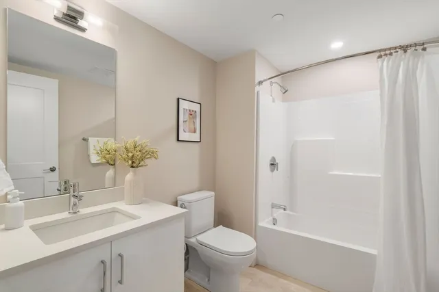 a bathroom with a sink toilet and shower