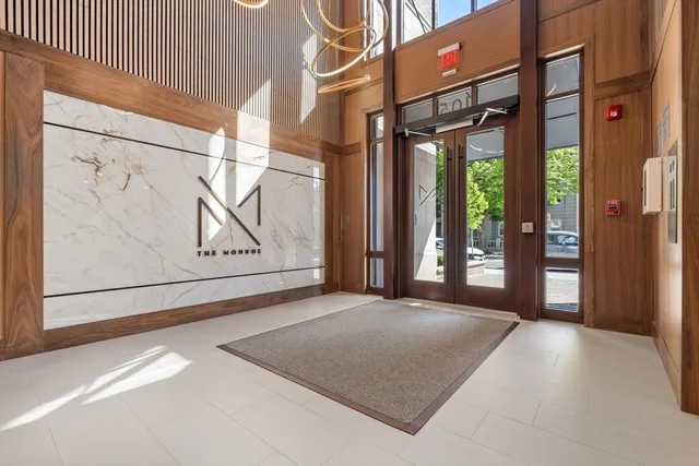 a view of a room with wooden floor and windows