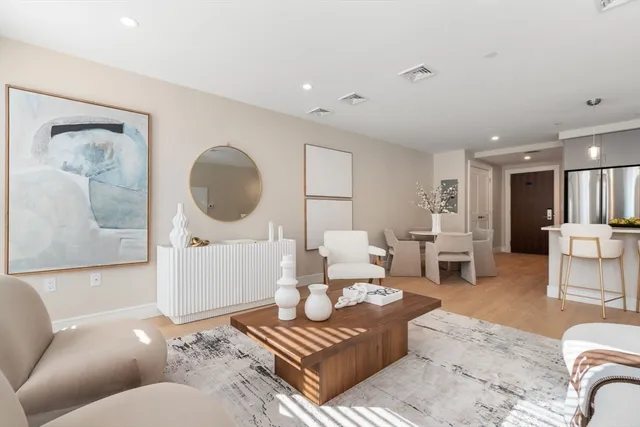 a living room with furniture and a mirror