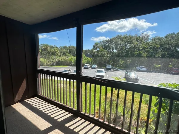 a view of balcony with wooden floor and fence