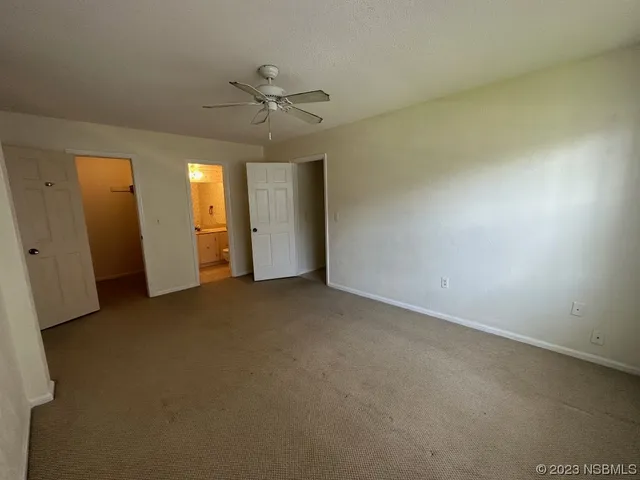 an empty room with closet and entryway