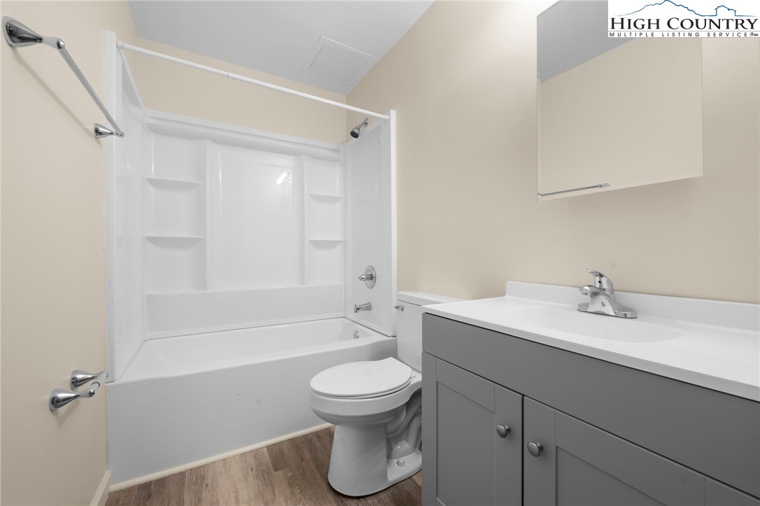 128 Zeb Street, Unit A101 Boone, NC 28607 - Photo 15 of 32 a bathroom with a sink a toilet and a shower