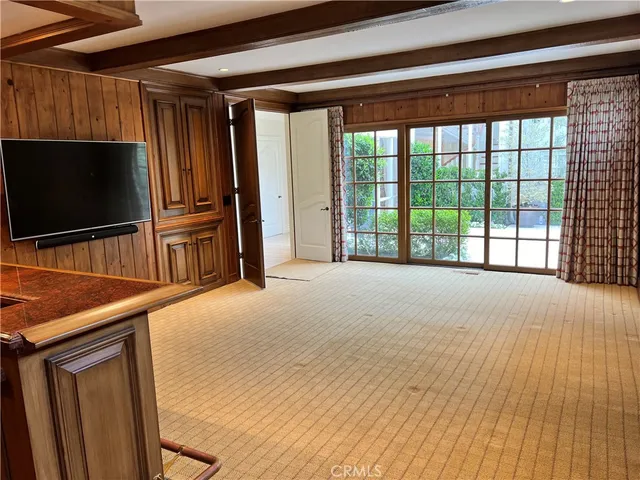 a view of a room with wooden floor and windows