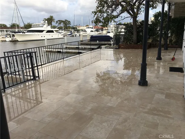 a view of a swimming pool with a patio and fire pit