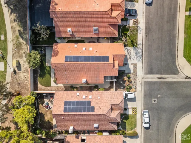 an aerial view of residential houses with outdoor space