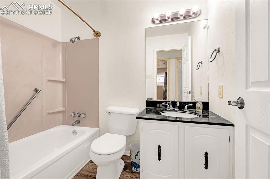 130 Scotland Road, Unit D Pueblo, CO 81001 - Photo 11 of 20 a bathroom with a bathtub sink vanity mirror and toilet