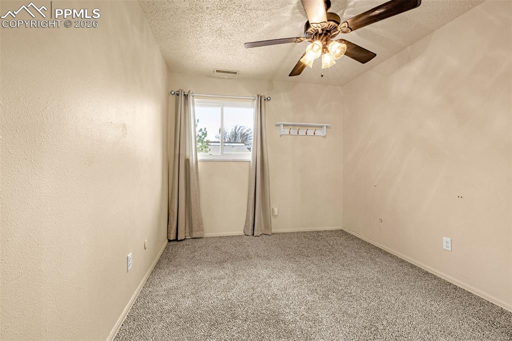 130 Scotland Road, Unit D Pueblo, CO 81001 - Photo 13 of 20 an empty room with windows and fan