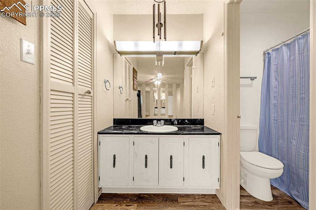 130 Scotland Road, Unit D Pueblo, CO 81001 - Photo 15 of 20 a bathroom with a granite countertop sink a toilet a mirror and shower