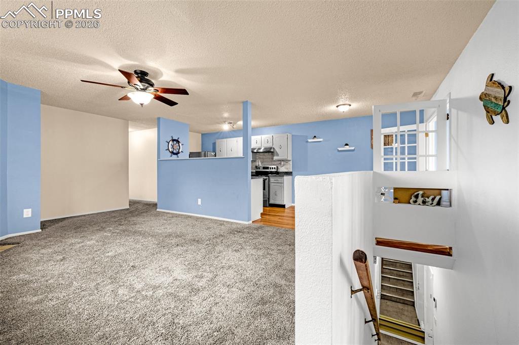 130 Scotland Road, Unit D Pueblo, CO 81001 - Photo 3 of 20 a view of a kitchen with refrigerator and cabinets