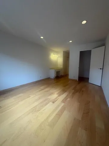 a bathroom with a granite countertop toilet sink and mirror