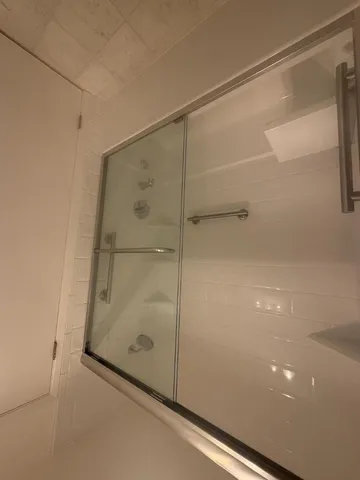 an empty room with a fireplace and window