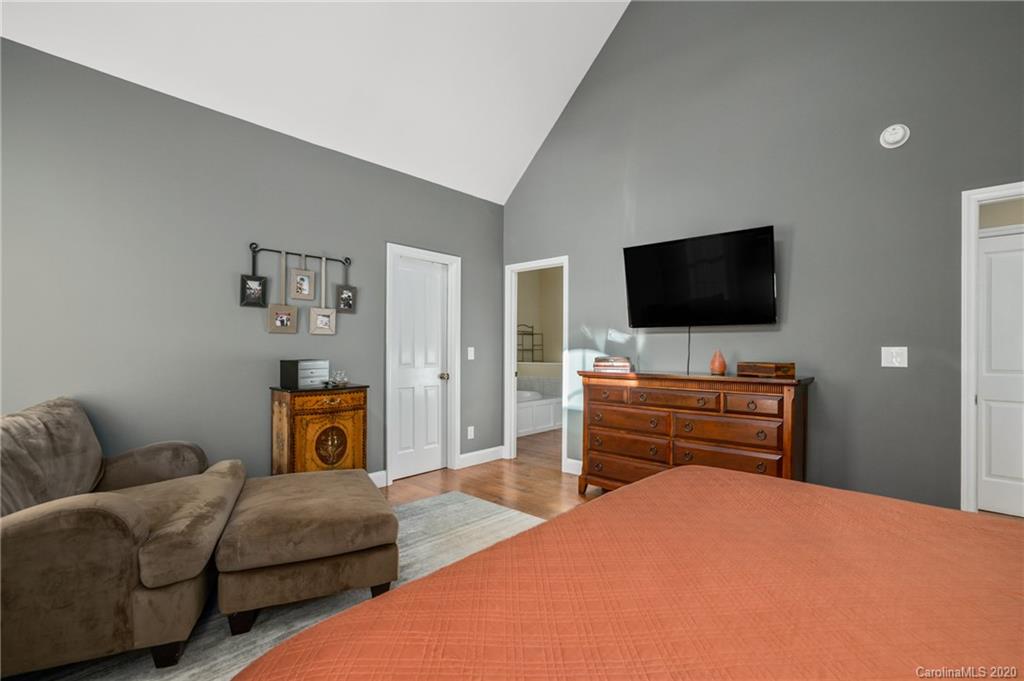 783 Big Level Road Mill Spring, NC 28756 - Photo 22 of 48 a bedroom with a bed and a flat screen tv