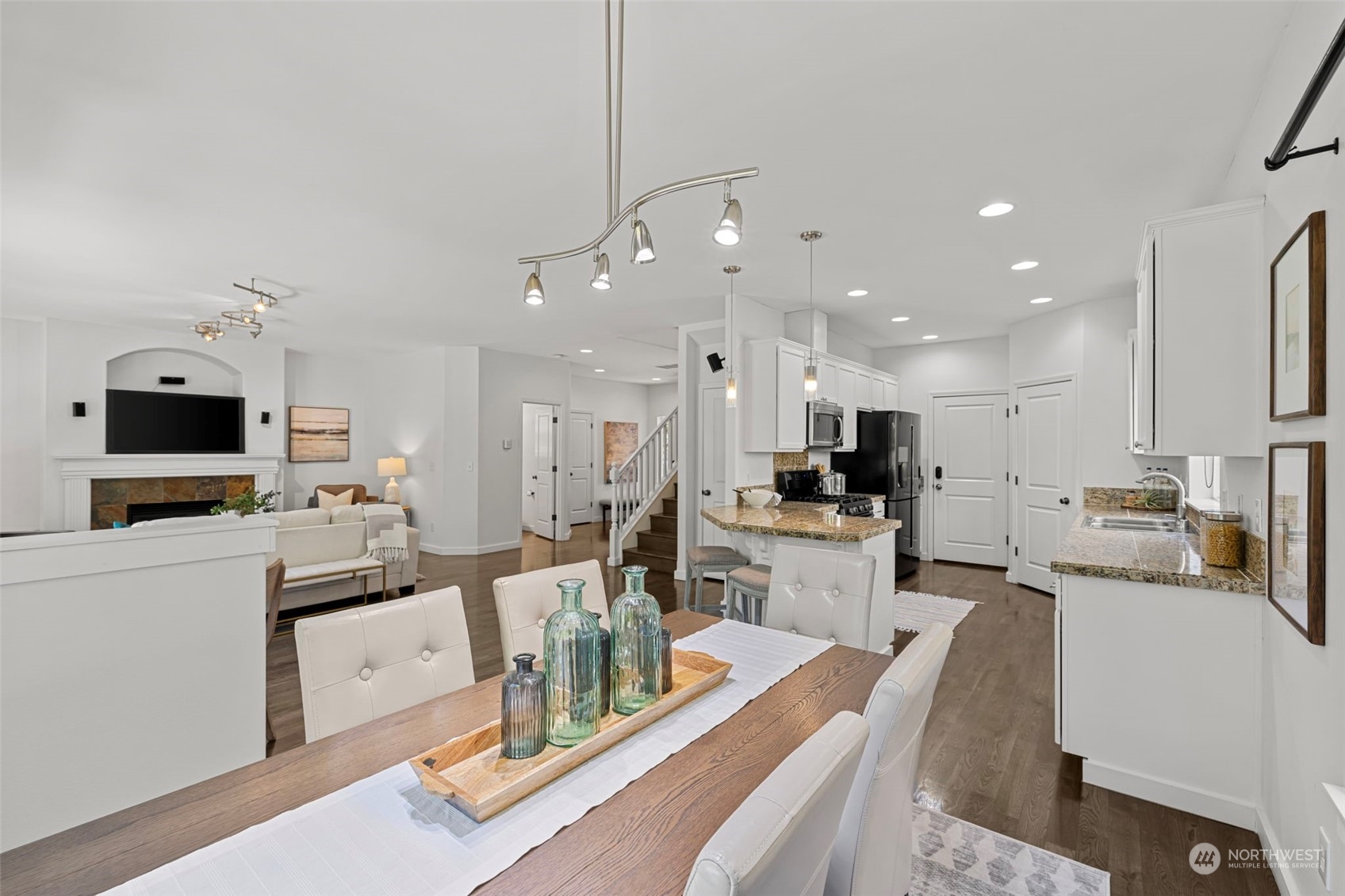 23825 17th Avenue West Bothell, WA 98021 - Photo 12 of 35 a kitchen with stainless steel appliances kitchen island sink stove and white cabinets with wooden floor