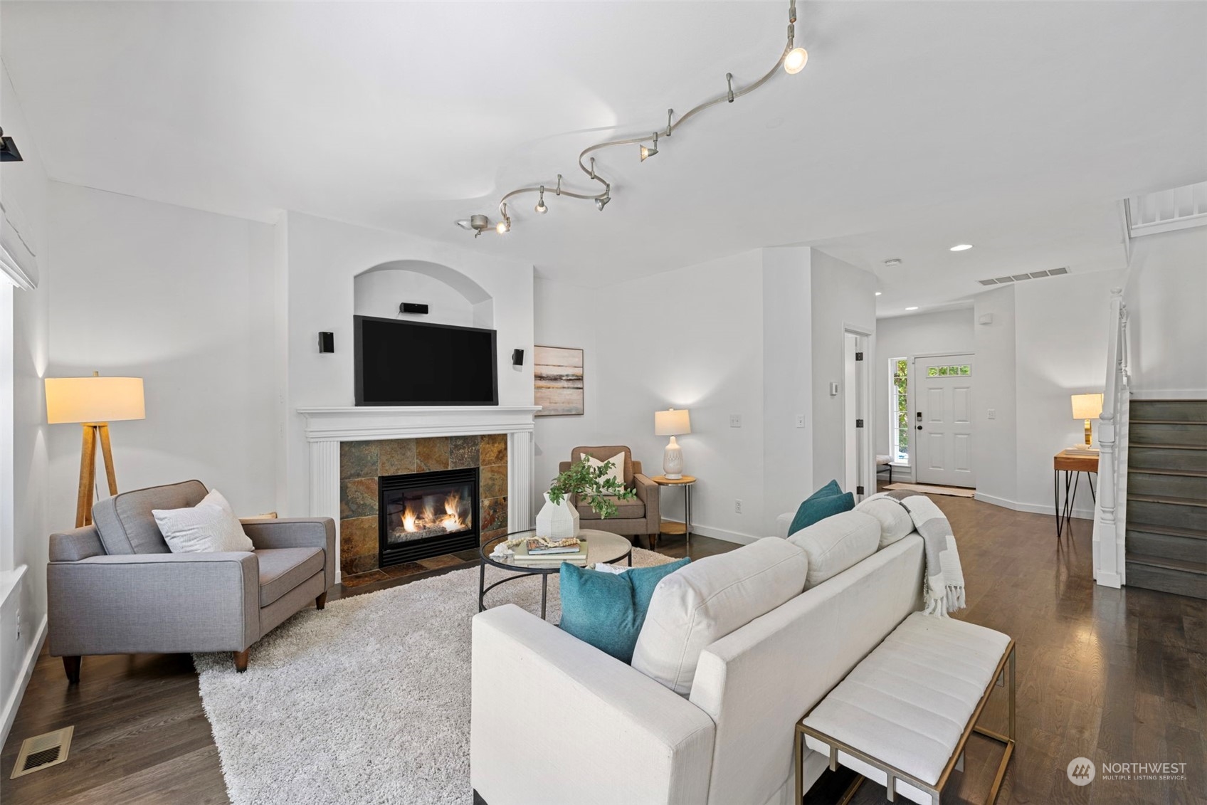 23825 17th Avenue West Bothell, WA 98021 - Photo 13 of 35 a living room with furniture a fireplace and a chandelier