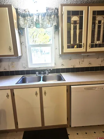 a view of a kitchen with a sink and a window