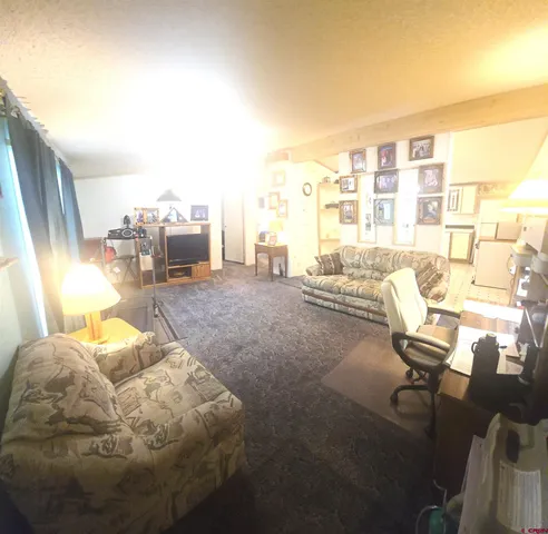 a workspace with furniture and floor to ceiling window