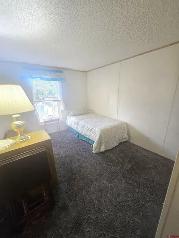 a spacious bedroom with a bed and a window