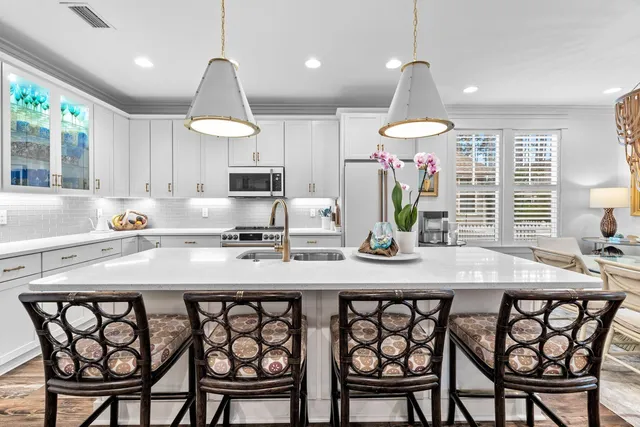 a kitchen with a table chairs stove and microwave